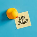 Baby shower party reminder message written on yellow sticky note with a rubber duck Royalty Free Stock Photo