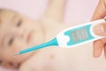 Baby sick with measuring electric thermometer. Child fever ill. Royalty Free Stock Photo