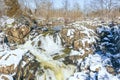 Baby sister falls on the Olmsted Island near Great Falls of the Potomac River in winter Royalty Free Stock Photo