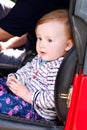 Baby sit in safety car seat. Cute little girl in car seats in car. Portrait of pretty toddler girl sitting in car seat. Royalty Free Stock Photo