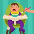 The baby sits in the feeding chair and refuses to eat when he is being fed. Royalty Free Stock Photo
