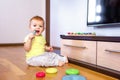 Baby sits and scratches his gum with a silicone brush Royalty Free Stock Photo