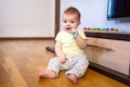 Baby sits and scratches his gum with a silicone brush Royalty Free Stock Photo