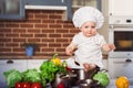 Baby sitting astride a stainless pan