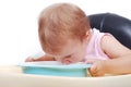 Baby sitting on the black chair eating Royalty Free Stock Photo