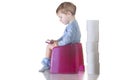 Baby sitting on chamber pot reading a book Royalty Free Stock Photo