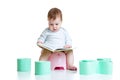 Baby sitting on chamberpot with book Royalty Free Stock Photo