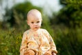 Baby sitting in field. nature walks with kids.