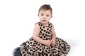 Baby sitting on the floor in a beautiful dress. Royalty Free Stock Photo