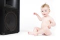 Baby sitting in front of loudspeaker