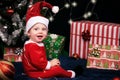 Baby sitting with gifts under christmas tree Royalty Free Stock Photo