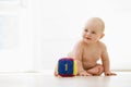 Baby sitting indoors with block smiling Royalty Free Stock Photo