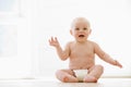 Baby sitting indoors smiling Royalty Free Stock Photo