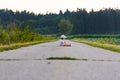 Baby sitting in the middle of a rural road leading to forest Royalty Free Stock Photo