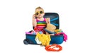 Baby is sitting in a suitcase, getting ready for a travel. Selective focus. Royalty Free Stock Photo