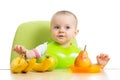 Baby sitting at table with fruits Royalty Free Stock Photo