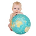 Baby sitting on white background with globe Royalty Free Stock Photo