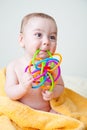 Baby Sitting on Yellow Towel Gnawing Toy Royalty Free Stock Photo