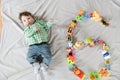 Baby six months top view. Happy baby in a hat and a diaper lying on the background of the carpet, smiling baby Toddler in a shirt Royalty Free Stock Photo