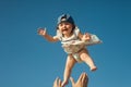 Baby and sky in the background on a sunny day. Young handsome father holding up his little cute daughter. Royalty Free Stock Photo