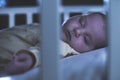 Baby sleep in a baby bed. Royalty Free Stock Photo