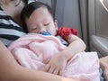 Baby sleep in car with dummy in mouth. Royalty Free Stock Photo