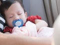 Baby sleep in car with pacifier in mouth. Royalty Free Stock Photo