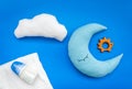 Baby sleep pattern with moon pillow, cloud, feeding bottle and toy on blue background top view