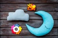Baby sleep pattern with moon pillow, cloud and toy on wooden background top view