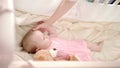 Baby sleep time. Toddler girl rest in cot. Little baby dream in crib