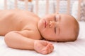 The baby is sleeping on the bed, a close-up portrait. Sleep time