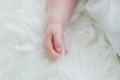 Baby Sleeping with Hands Curled Against White Blanket