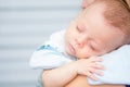 Baby sleeping on his mother`s shoulder Royalty Free Stock Photo