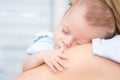 Baby sleeping on his mother`s shoulder Royalty Free Stock Photo