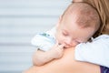 Baby sleeping on his mother`s shoulder Royalty Free Stock Photo