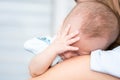 Baby sleeping on his mother`s shoulder Royalty Free Stock Photo