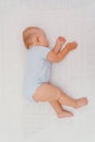 Baby sleeping on its side on a white blanket, top view Royalty Free Stock Photo