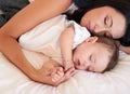 Baby, sleeping and mother holding hands on bed with parent support, care and love. Relax, home and child sleep with mom Royalty Free Stock Photo