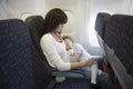 Baby Sleeping On Mother's Laps In Airplane