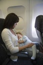 Baby Sleeping On Mother's Laps In Airplane