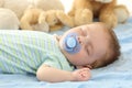 Baby sleeping with a pacifier