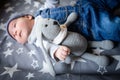 The baby is sleeping with a toy. a small child sleeps by the window, dreaming of a starry sky before going to bed. sleep concept.
