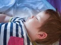 Baby sleeps in parents bed. arms outstretched baby`s restful sleep. close-up. child 0-1 years old. adorable lovely baby sleeps