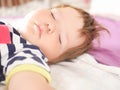 Baby sleeps in parents bed. arms outstretched baby`s restful sleep. close-up. child 0-1 years old. adorable lovely baby sleeps