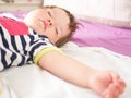 Baby sleeps in parents bed. arms outstretched baby`s restful sleep. close-up. child 0-1 years old. adorable lovely baby sleeps