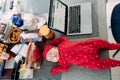 Baby sleeps on a table near an open laptop