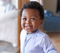 Baby, smile or teeth in childcare, health or growth in play, leisure and relaxation in living room. Happy, black boy or Royalty Free Stock Photo