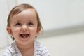 Baby, smiling and playing on floor, child development and infant growth with face, sitting and home. Girl, joyful and Royalty Free Stock Photo