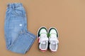 Baby sneakers and jeans pants. Set of children`s clothes and accessories for spring, autumn or summer. Fashion kids outfit, Royalty Free Stock Photo