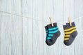 Baby socks on laundry line against wooden background. Child accessories Royalty Free Stock Photo
